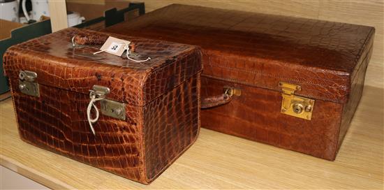 A crocodile suitcase and another